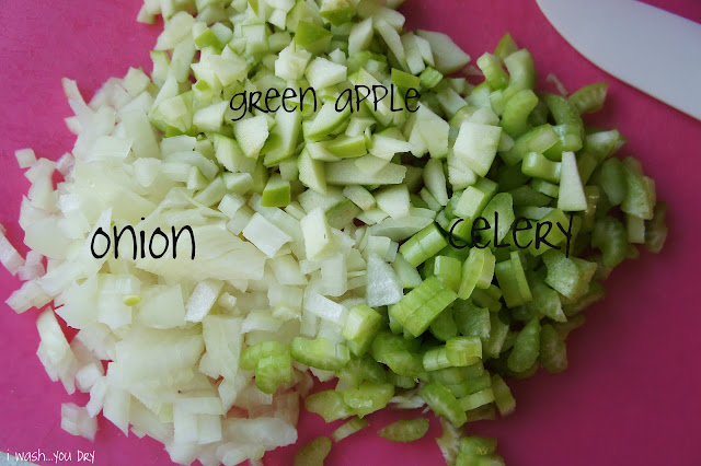 Chopped onions, green apples and celery on a cutting board.