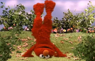 Dorothy is imagining elmo doing a handstand. Sesame Street Elmo's World Hands Tickle Me Land