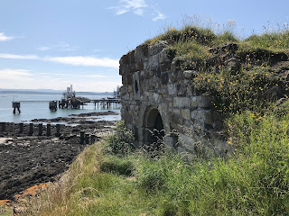 The Monk’s Cave entrance with the industrial, metal structure of Braefoot Terminal in the background.  Photo by Kevin Nosferatu for the Skulferatu Project.