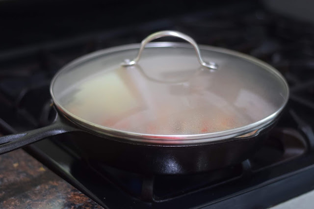 The pan, on the stove, with a lid atop it. 