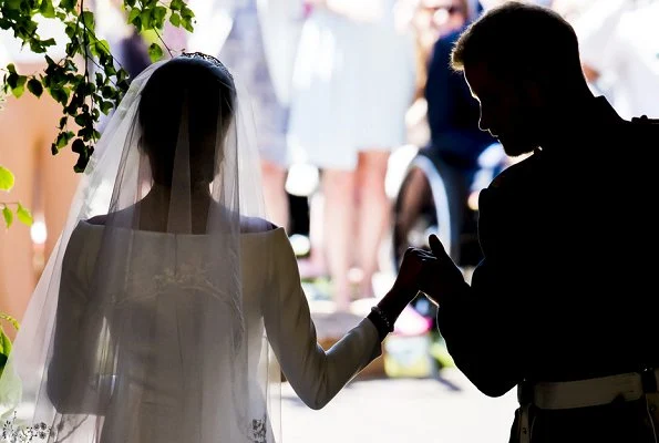 Markle wore a silk organza boat neck long sleeve wedding dress designed by famous British designer Clare Waight Keller.