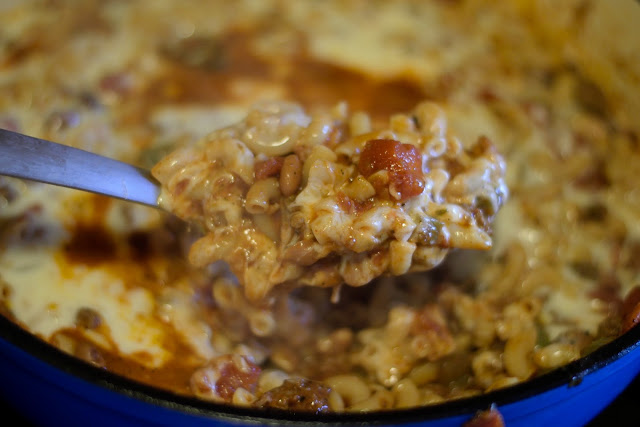 The finished beef and bean goulash being scooped from the pan.