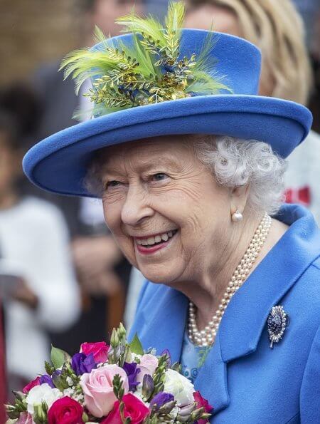 Queen Elizabeth opened the new housing development of Haig Housing. Pearl earring and pearl necklace, diamond brooch