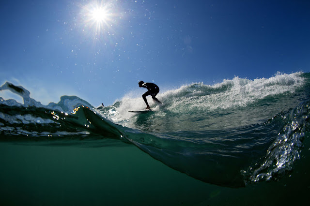 A surfer rides a wave in Varazze during a day of high swell due to strong winds 