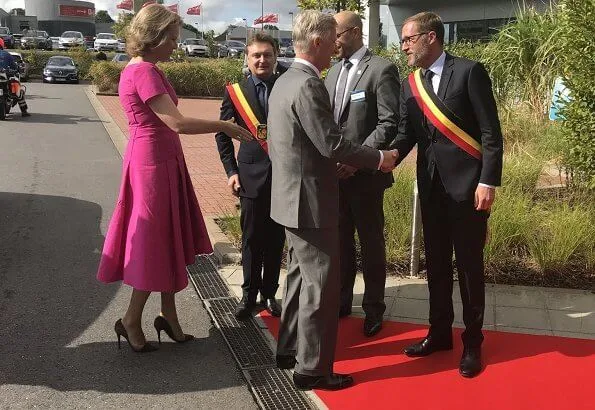 Queen Mathilde wore a pink asymmetric midi dresses by Natan.Arthur Regniers medical and pedagogical center