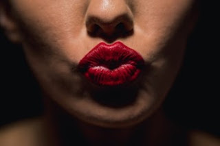 Woman pursing lips after lip filler treatment