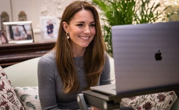 Kate Middleton wore a new fine ribbed knit top from Alexander McQueen, pearl curb chain earrings from Simone Rocha