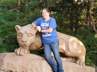 I'm posing for a picture in front of the nittany lion statue.