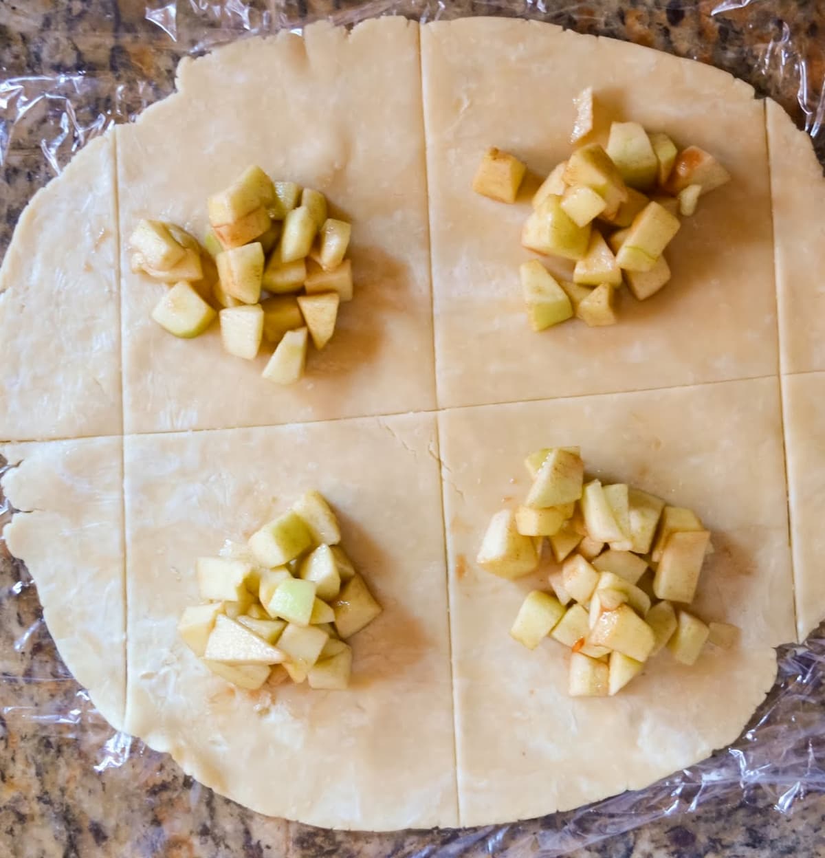 Apple mixture placed on rolled out pie squares.