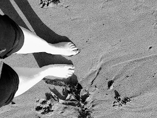 Bare feet in fine sand.