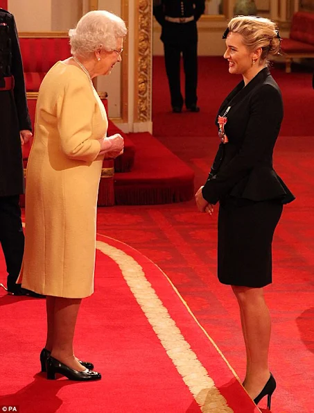 Kate Winslet awarded CBE by The Queen at Buckingham Palace. Kate Winslet in Alexander McQueen at Investiture Ceremony