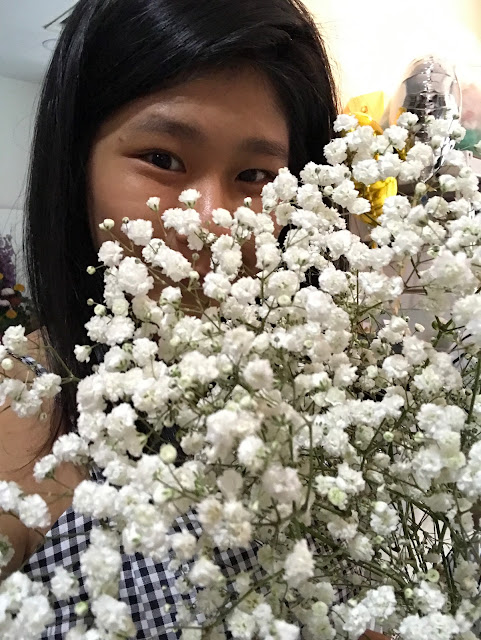 angie and some baby breath ; a better florist , flower arrangement class