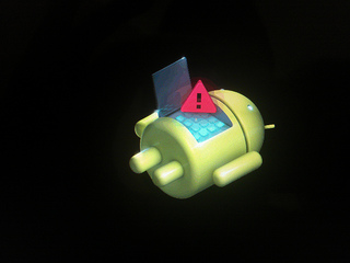 Pictured: the Android robot on its back, with an exclamation mark inside a red triangle.