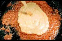 Adding curd mix into tomato onion gravy for chicken do pyaza recipe