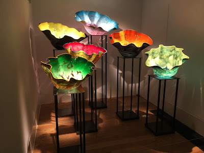 photo of 6 large glass scupltures,like giant glass poppies in bright colours