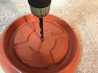 Drilling a hole in the center of the saucer