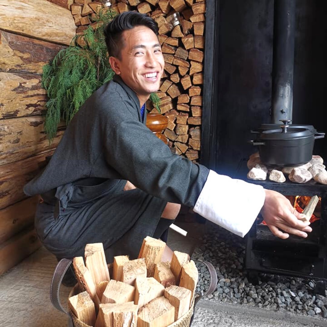 smiling boy traditional cooking with firewood