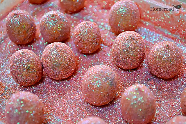 rolling acorns in glitter