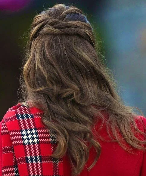 Kate Middleton wore a tartan pleated skirt from Emilia Wickstead, yellow gold hoops from Spells of Love. Alexander McQueen red coat. Grace Han bag