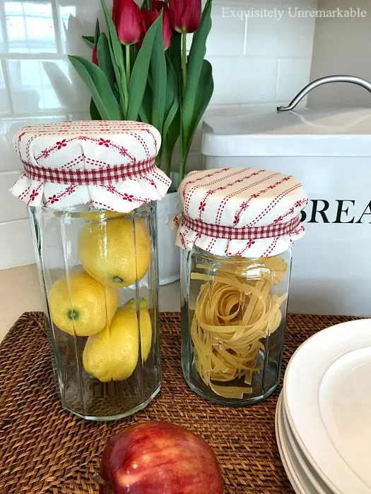 Glass Canisters filled with fruit and pasta