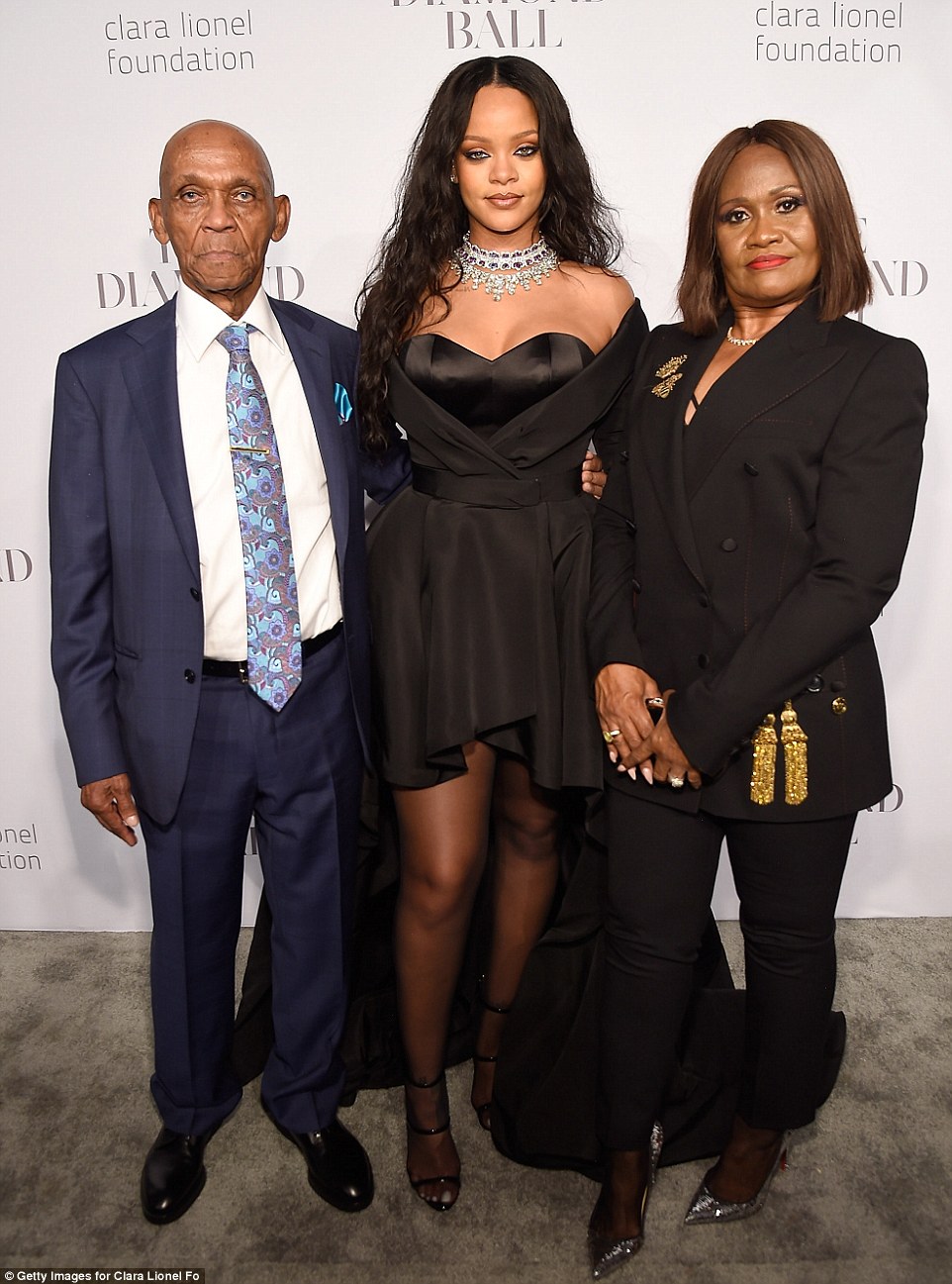 Rihanna poses with her parents at her 3rd annual Diamond ball This Is