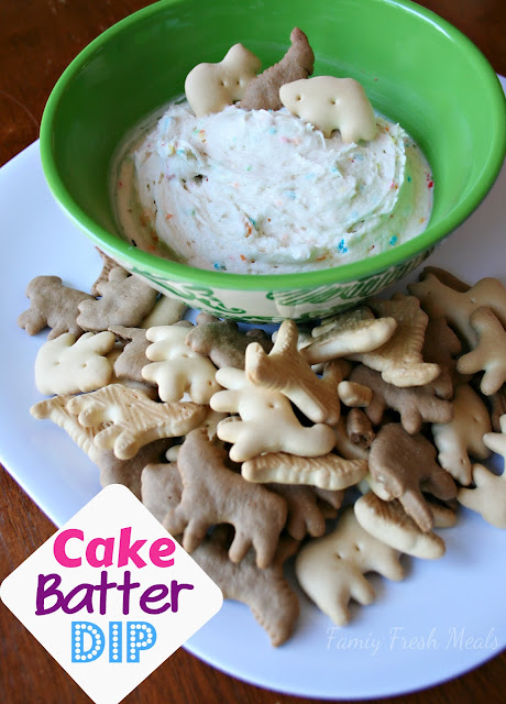 a bowl of cake batter dip served with animal crackers