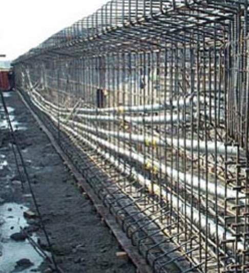 A 250 ft girder is arranged for prestressing after concrete casting