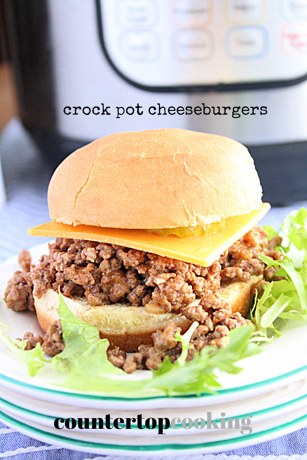 Crock Pot Cheeseburger swerved on in a plate with the slow cooker in the background. Photo and recipe  by Table for Seven