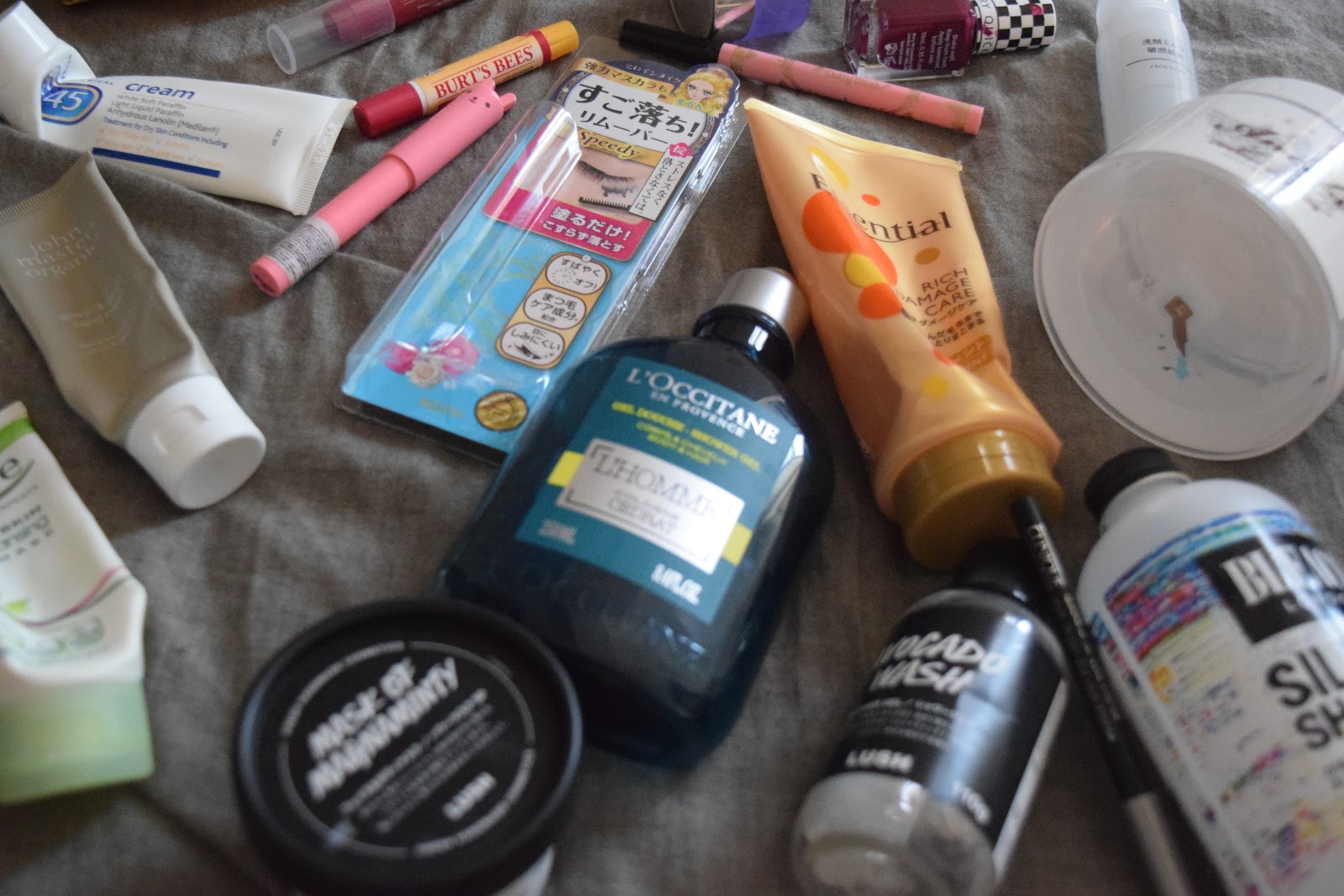 Flatlay of empty beauty products including skincare, makeup and hair care