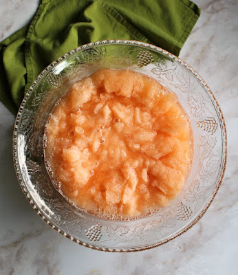 peach slush in glass punch bowl, waiting for soda to be poured in