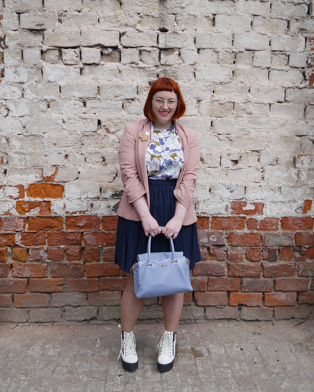 Casual summer style what Helen wore, red head, See with Iolla, Iolla clear glasses, clear spectacles, Scottish blogger, scottish fashion blogger, Dundee blogger, Dundee event, Dundee, cat lady, crazy cat lady outfit, cat top, H&M outfit, blue skirt, pleated navy skirt, charity shop shoes, white lace up boots, pink blazer, Lucky Dip Club pin, Kate Rowland wooden brooch, Bonnie Bling necklace, Scottish slang necklace, peely wally necklace, Scottish street style, brick wall background, cat print top