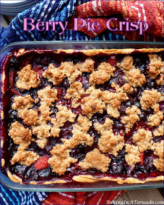Berry Pie Crisp is a summertime favorite. An assortment of berries, mixed with a bit of toffee and baked as a pie, crisp hybrid. | Recipe developed by www.BakingInATornado.com | #recipe #pie