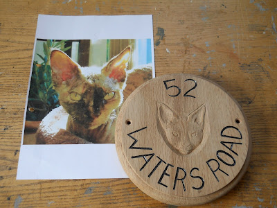 carved portrait of a cat in wood