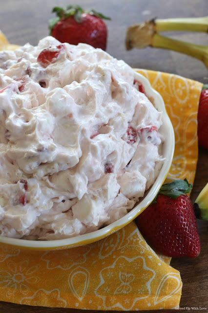 Strawberry and banana in a yogurt based creamy sauce in a large bowl
