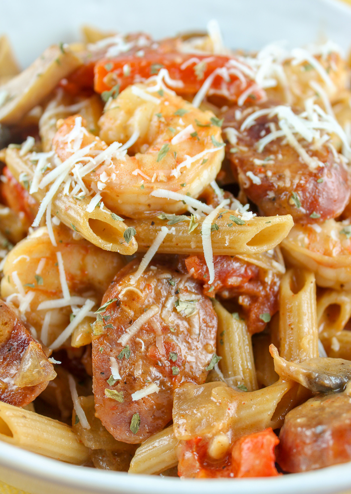 This Cajun Shrimp and Sausage Pasta is quick to make and you can have it as spicy as you like! Fat Tuesday and Mardi Gras won't know what hit 'em! Pasta mixed with shrimp, andouille, onions, peppers & mushrooms all smothered in a spicy creamy tomato sauce! It's heavenly!