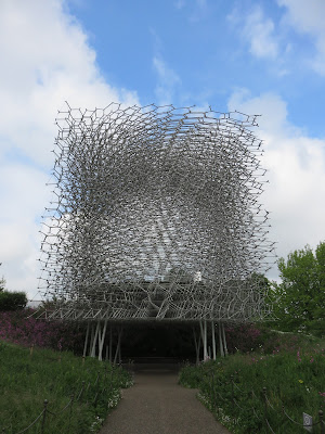 Photo of 'the hive' sculpture at Kew -interlocking aluminium framework, against a cloudy sky