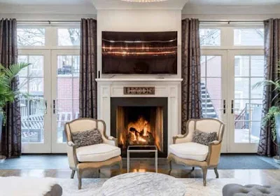 Living room with fireplace and luxury armchairs.