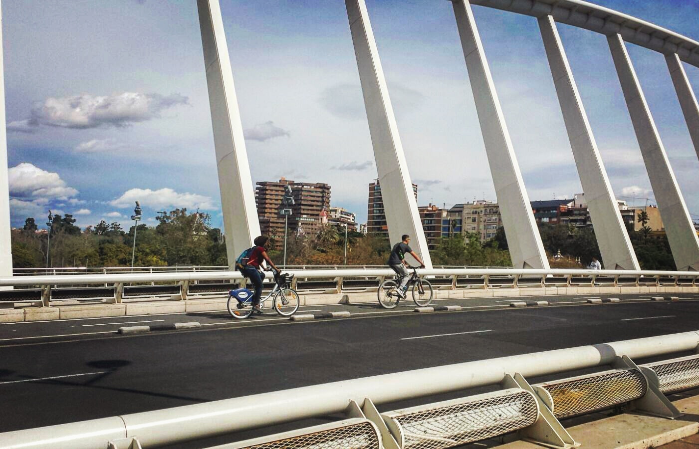 Cyclists crossing Pont de l'Exposició, by Santiago Calatrava, in Valencia, Spain