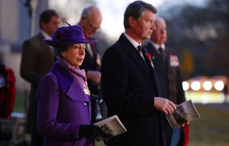 Princess Anne wore an eye-catching purple coat and matching hat, a pale lilac scarf and black knee-high boots