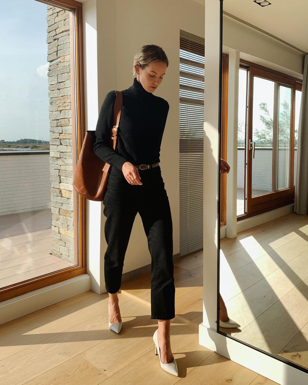 Copy This Chic Fall Look with a Few Classic Pieces — @anoukyve in black turtleneck, brown shoulder bag, black straight-leg jeans, and white heels