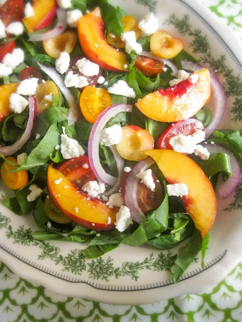 This Peach and Cherry Salad is lite and fresh with red onions and a sprinkle of feta on my favorite bed of leafy greens and tender collard ribbons.