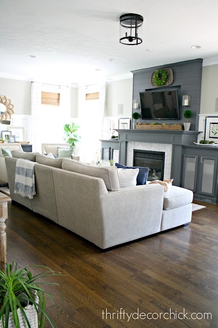 large gray fireplace with cabinets built in