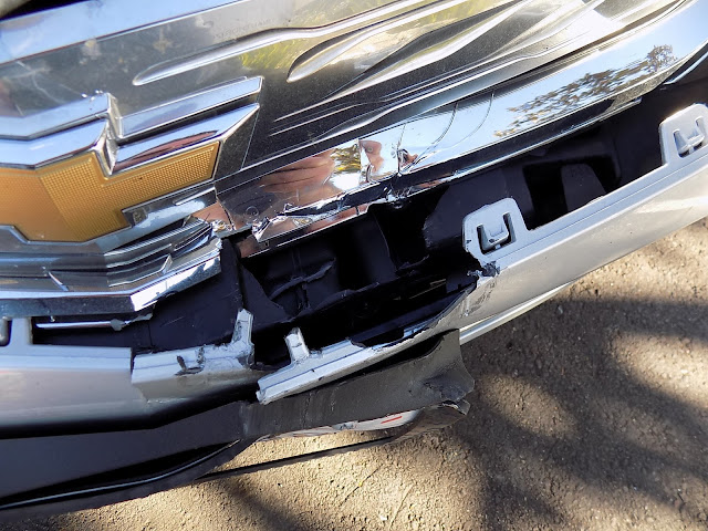 Close up of interior bumper damage on 2017 Chevy Volt before collision repairs at Almost Everything Auto Body.