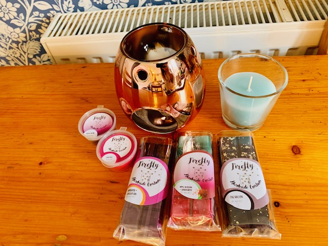 A selection of wax melts with a rose gold burner