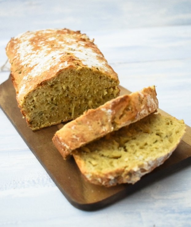 vegan beer bread thickly sliced on a wooden board