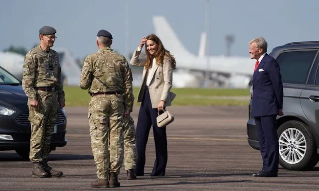 Kate Middleton wore a new double-breasted blazer by Reiss Larsson, and high waisted sport luxe trousers by Jigsaw