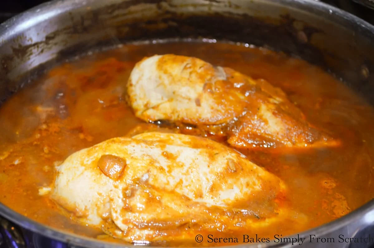 Cooked Chicken Breast in Red Enchilada Sauce.