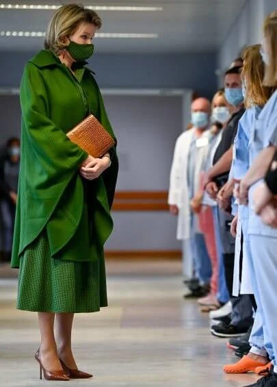Queen Mathilde wore a green wool cashmere cape coat from Natan, and green checked viscose canvas midi dress from Belgian fashion house Natan