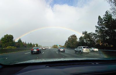 Driving on the freeway towards a rainbow on a rainy day