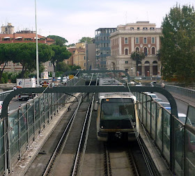 A Linea A metro train crosses the Ponte Pietro Nenni, which carries trains over the River Tiber in Rome